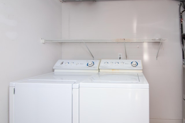 washroom with washing machine and clothes dryer