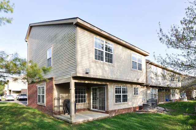back of property with a lawn