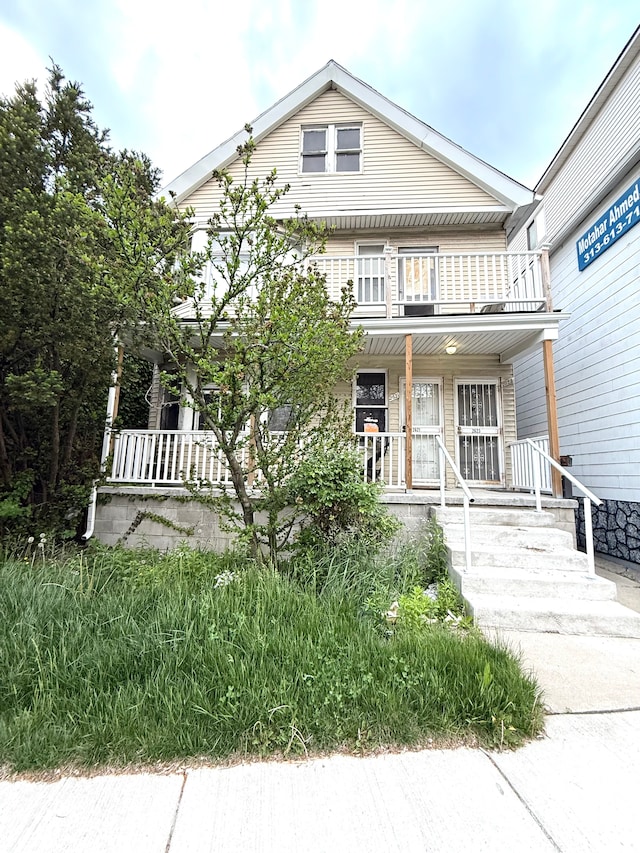view of front of house with covered porch and a balcony