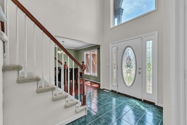 20261 Ramblewood Dr, Macomb, MI 48044 - foyer entrance with healthy amount of natural light, stairs, dark tile patterned flooring, baseboards, and a high ceiling