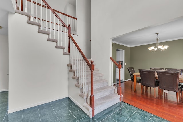 20261 Ramblewood Dr, Macomb, MI 48044 - stairway featuring ornamental molding, a chandelier, baseboards, and wood finished floors