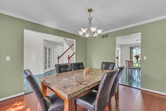 20261 Ramblewood Dr, Macomb, MI 48044 - dining room with baseboards, stairs, a chandelier, crown molding, and dark wood-type flooring
