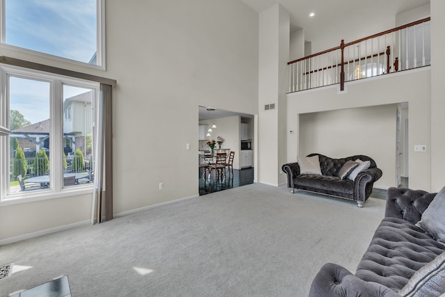 20261 Ramblewood Dr, Macomb, MI 48044 - carpeted living area featuring a high ceiling and baseboards