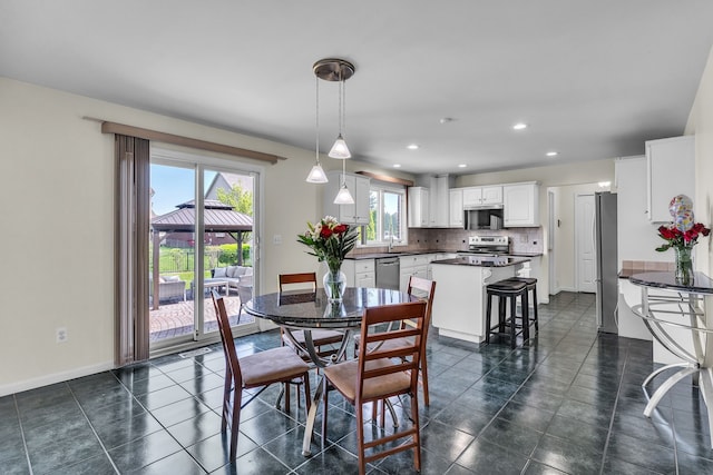 20261 Ramblewood Dr, Macomb, MI 48044 - dining space with recessed lighting, baseboards, and dark tile patterned floors