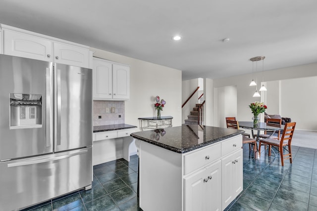 20261 Ramblewood Dr, Macomb, MI 48044 - kitchen featuring stainless steel refrigerator with ice dispenser, a center island, decorative light fixtures, white cabinets, and tasteful backsplash