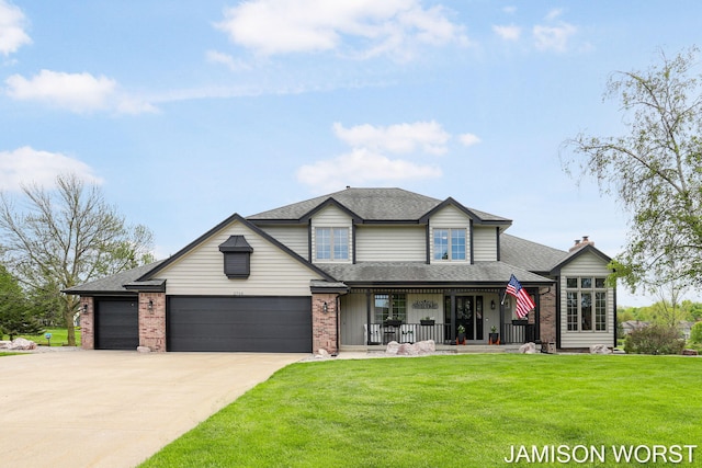 view of front of house featuring a porch, a front lawn, an attached garage, driveway, and brick siding