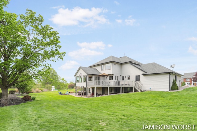 rear view of property with stairs, a wooden deck, a patio, and a lawn