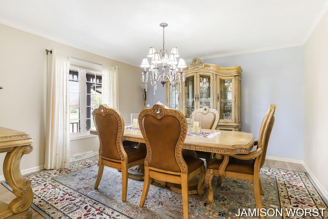 dining space with a chandelier, baseboards, and crown molding