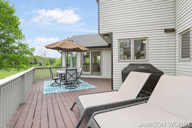wooden terrace with outdoor dining space