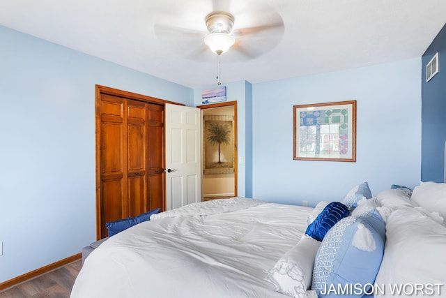 bedroom with dark wood-style flooring, baseboards, a closet, and a ceiling fan