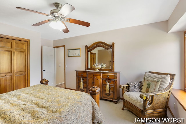 bedroom with light colored carpet, a closet, and ceiling fan