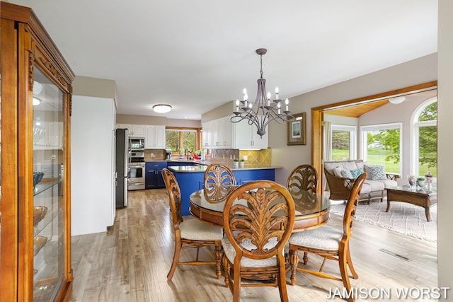 dining area featuring a chandelier and light wood-style floors