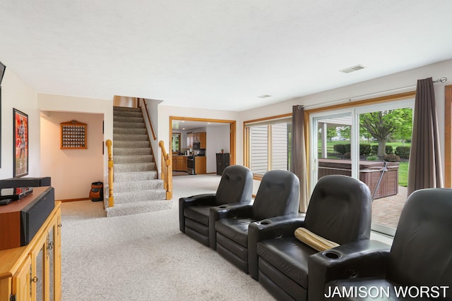 carpeted living area featuring stairway and baseboards