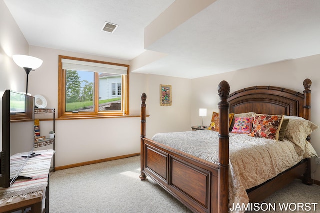 bedroom featuring light colored carpet and baseboards