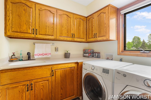 laundry room with washer and clothes dryer and cabinet space