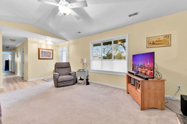 24459 Surfside Rd, Novi, MI 48374 - living area featuring light colored carpet, baseboards, vaulted ceiling, and a ceiling fan