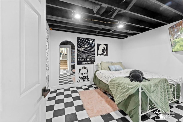 bedroom featuring tile patterned floors and arched walkways