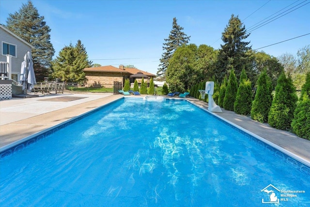view of swimming pool featuring a gazebo and a patio area