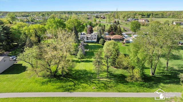 drone / aerial view of a tree filled landscape