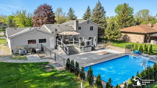 rear view of property featuring a patio and a wooden deck