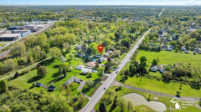 aerial overview of property's location with a nearby body of water and nearby suburban area
