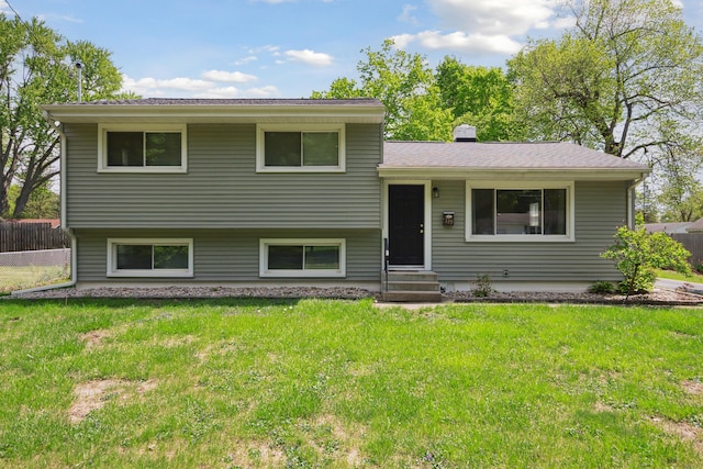 tri-level home featuring a chimney and entry steps