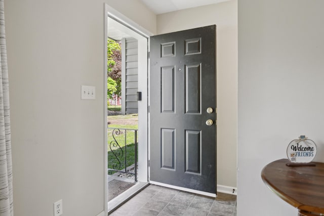 entryway featuring baseboards and tile patterned flooring