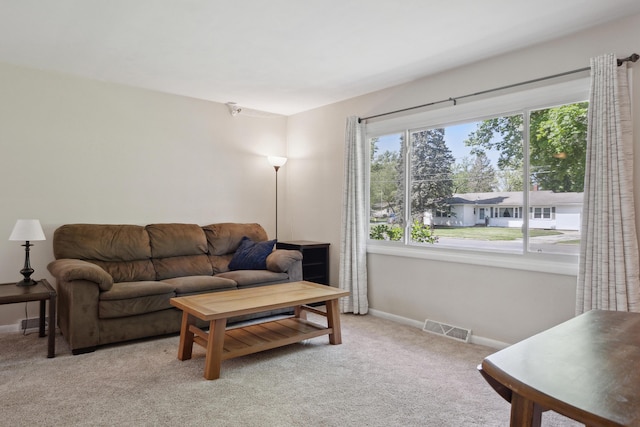 living room featuring baseboards and light carpet