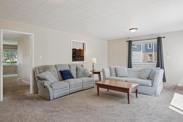 living room with plenty of natural light and carpet floors
