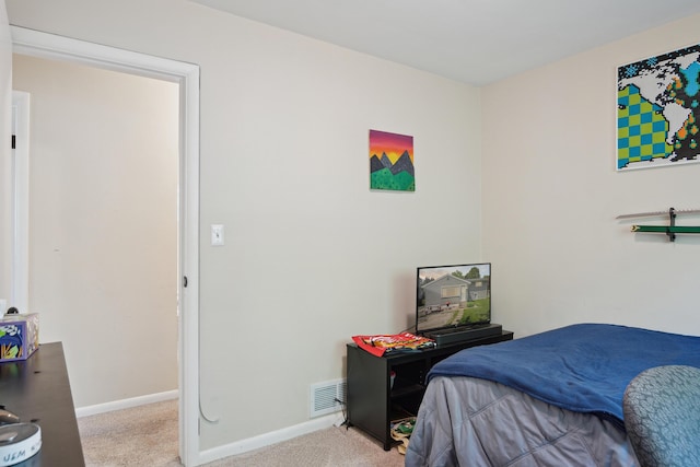 bedroom with carpet floors and baseboards