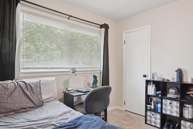 carpeted bedroom featuring baseboards