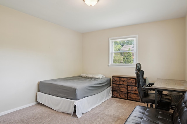 bedroom featuring carpet flooring, an office area, and baseboards