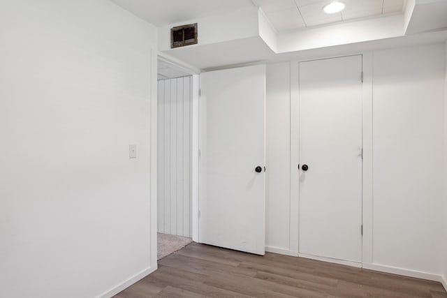 unfurnished bedroom featuring wood finished floors and a closet