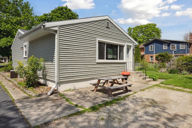 view of side of property with a patio area and fence