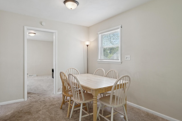 dining room with carpet and baseboards