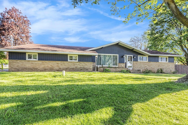single story home featuring brick siding and a front lawn
