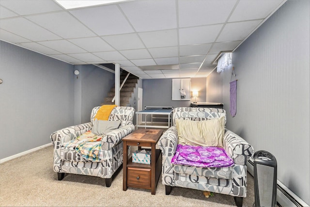 sitting room with a paneled ceiling, carpet floors, baseboards, stairway, and a baseboard radiator