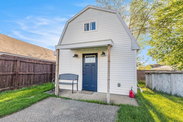 back of property with a gambrel roof and an outdoor structure
