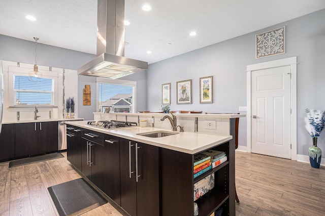 3080 Silver Fir Ct, Holland, MI 49424 - kitchen with island exhaust hood, a sink, stainless steel gas cooktop, light countertops, and open shelves