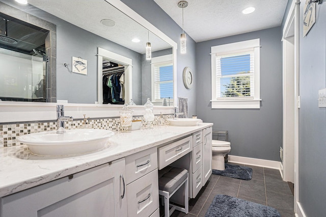 3080 Silver Fir Ct, Holland, MI 49424 - full bath featuring a shower stall, toilet, tasteful backsplash, baseboards, and double vanity