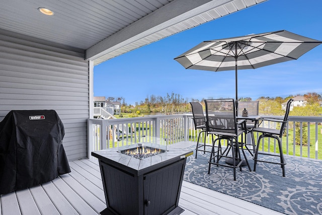 3080 Silver Fir Ct, Holland, MI 49424 - wooden deck featuring an outdoor fire pit, outdoor dining area, and area for grilling