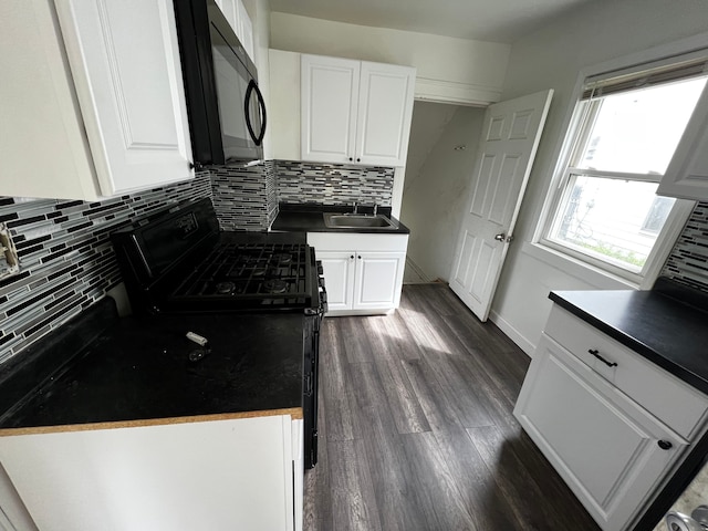 63 Hamilton St, Pontiac, MI 48342 - kitchen featuring a sink, black appliances, tasteful backsplash, and white cabinets