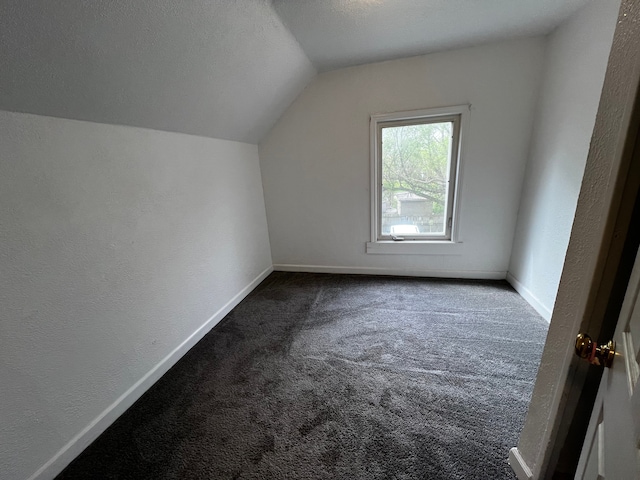 63 Hamilton St, Pontiac, MI 48342 - bonus room with lofted ceiling, dark carpet, baseboards, and a textured wall