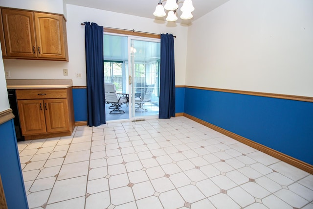 6339 Westchester St, Portage, MI 49024 - unfurnished dining area with a chandelier, light flooring, and baseboards