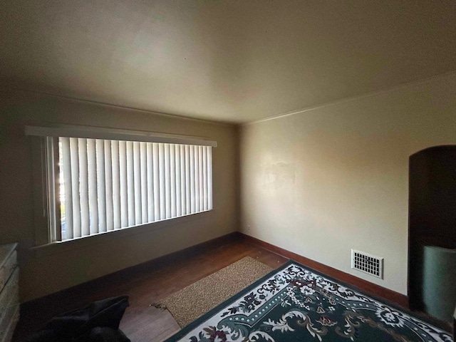 17330 Waltham St, Detroit, MI 48205 - unfurnished room with dark wood finished floors, baseboards, crown molding, and arched walkways