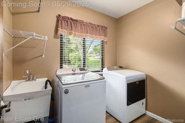 4976 Ledgewood Dr, Commerce Twp, MI 48382 - washroom with washing machine and dryer and wood finished floors