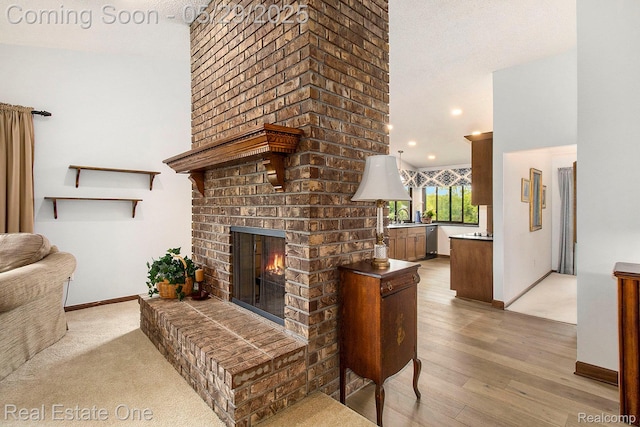4976 Ledgewood Dr, Commerce Twp, MI 48382 - living room with a brick fireplace, light wood finished floors, and recessed lighting
