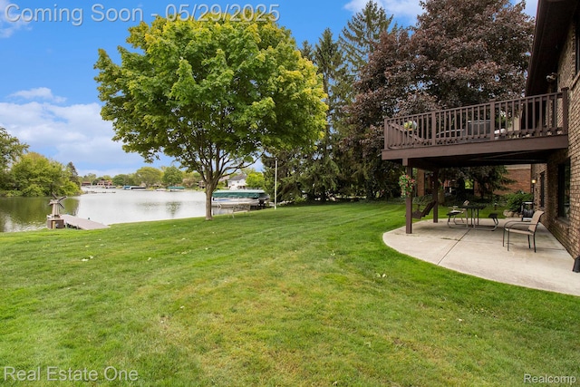 4976 Ledgewood Dr, Commerce Twp, MI 48382 - view of green lawn featuring a patio area and a deck with water view