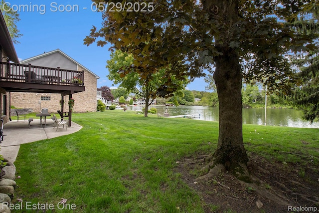 4976 Ledgewood Dr, Commerce Twp, MI 48382 - view of grassy yard featuring a patio area and a deck with water view