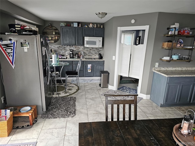 8889 Anchor Bay Dr, Clay, MI 48001 - kitchen with stainless steel fridge with ice dispenser, white microwave, backsplash, and light countertops